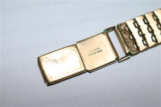 A gentlemans 1940s 9ct gold Omega wrist manual wind watch, with black Arabic dial on rolled gold bracelet.